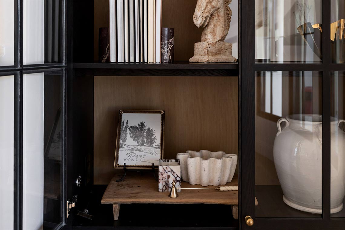 A room with beige limewashed walls, modern furniture, and neutral designer home accessories.
