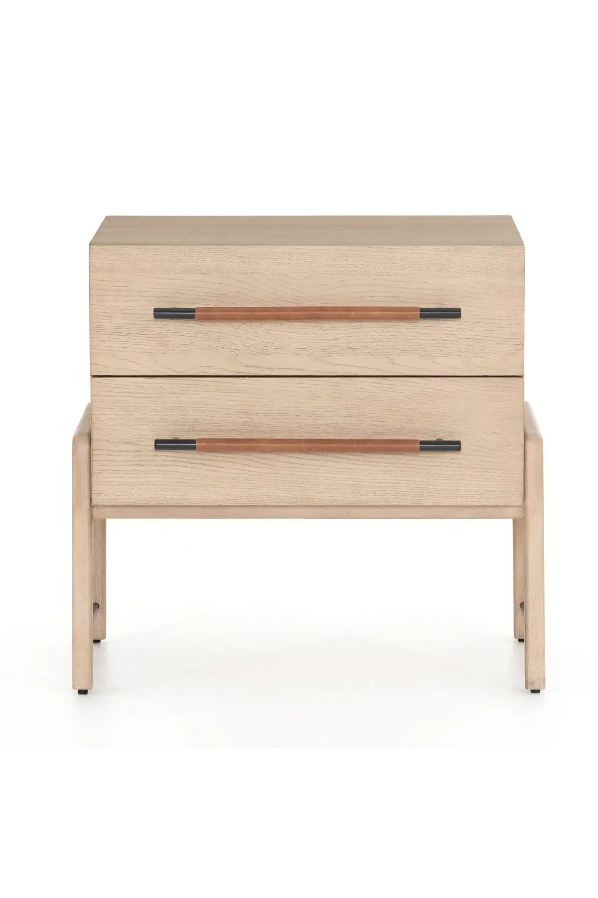 A light-finished oak nightstand with dual drawers featuring iron hardware wrapped in tan top-grain leather, with a clean silhouette and solid oak construction.