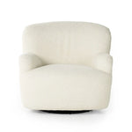 A beige upholstered Kadon swivel chair with a high wing back and softly rolled arms, standing on a white background.