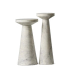 A set of two marble nesting end tables made of veined white marble with staggered heights.