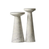 A set of two marble nesting end tables made of veined white marble with staggered heights.
