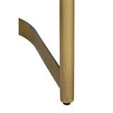 Close-up of a gold metal leg on the Shay Dining Chair on a white background