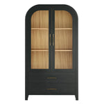 A black Liam Cabinet with arched doors, showcasing a natural oak interior with brass hardware, two shelves and two drawers.