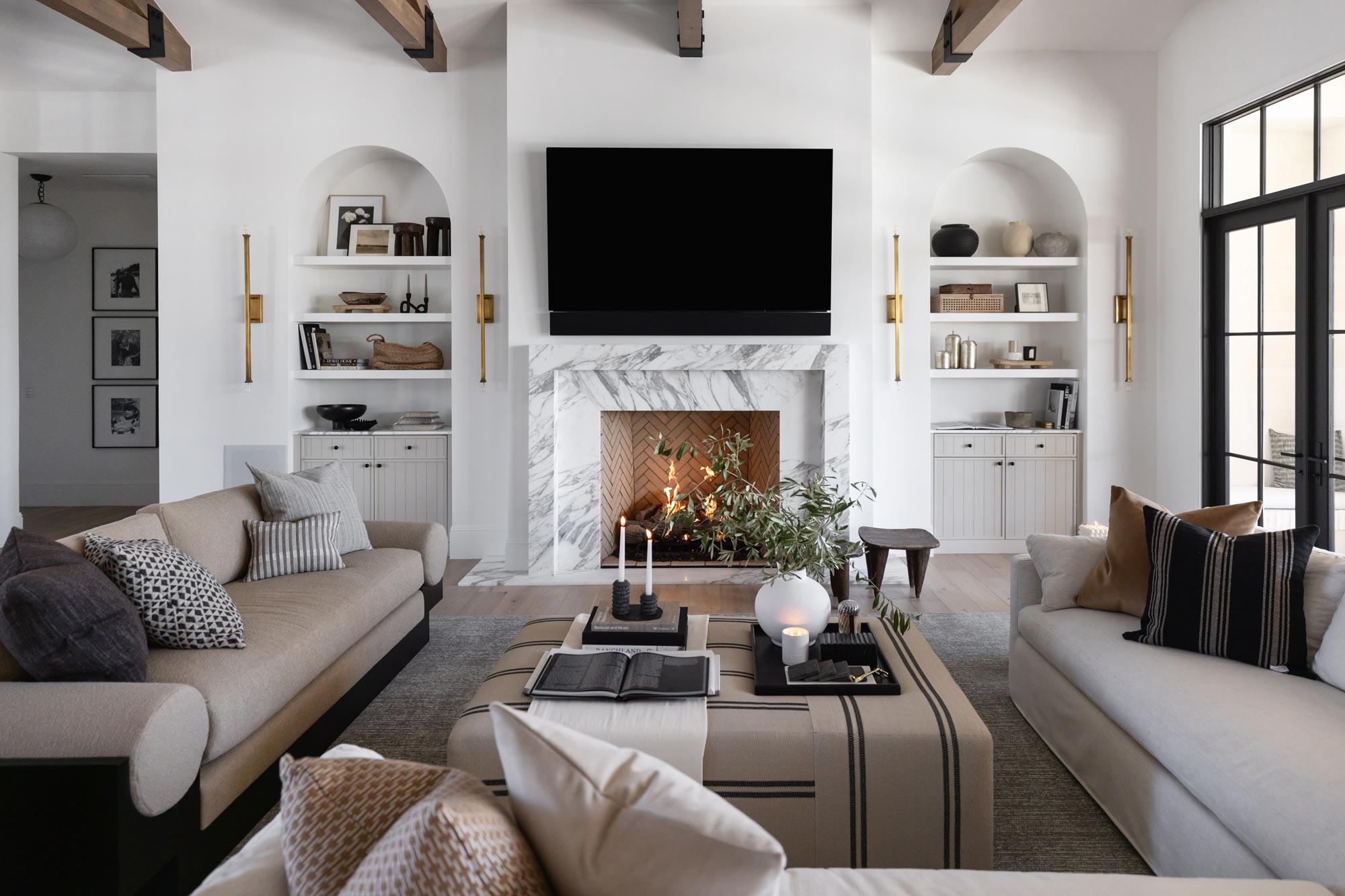 Redesigned living room with large fireplace, tv, bookshelves, and seating area