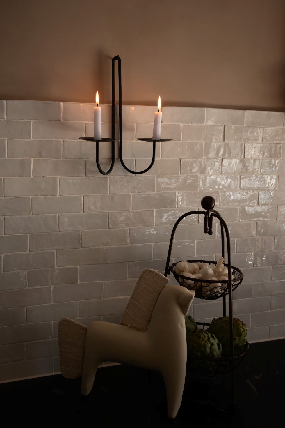 Decorative elm double wall sconce black iron sconce with candles on a brick wall background and decor items