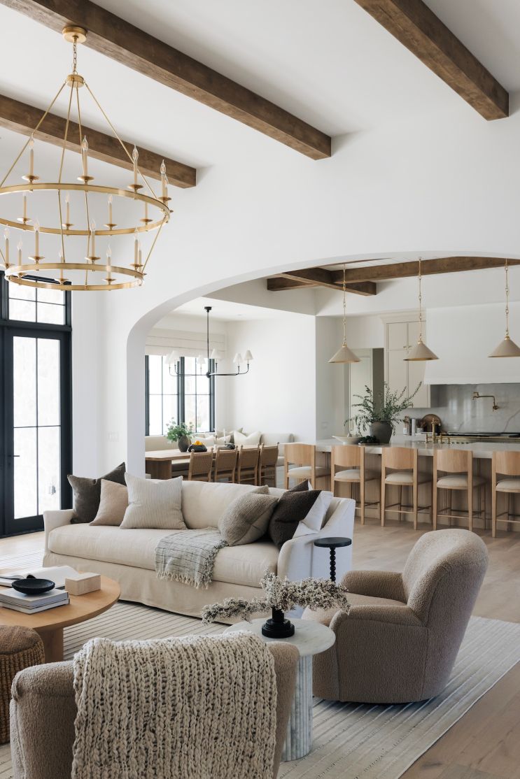 Modern living room with neutral tones and wooden beams with the Kadon Swivel chair
