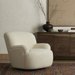 The Kadon Swivel Chair upholstered seating in neutral tones next to a console on a rug