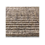 A close-up of a textured woven area rug or mat with horizontal ridges in a heathered beige and brown tone, shown against a white background.