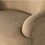 Close-up of a textured beige  upholstered seating on a white background