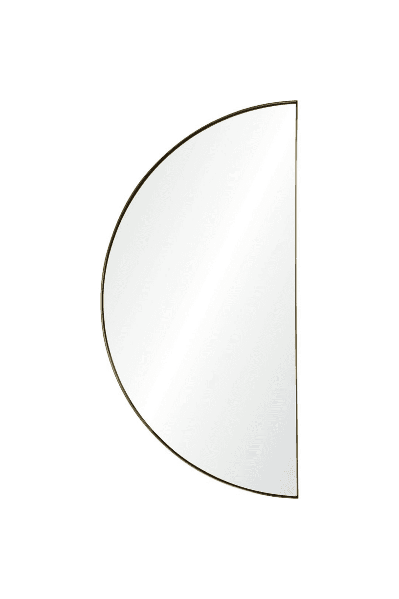 A wall-mounted half-moon mirror with a satin brass framed edge.